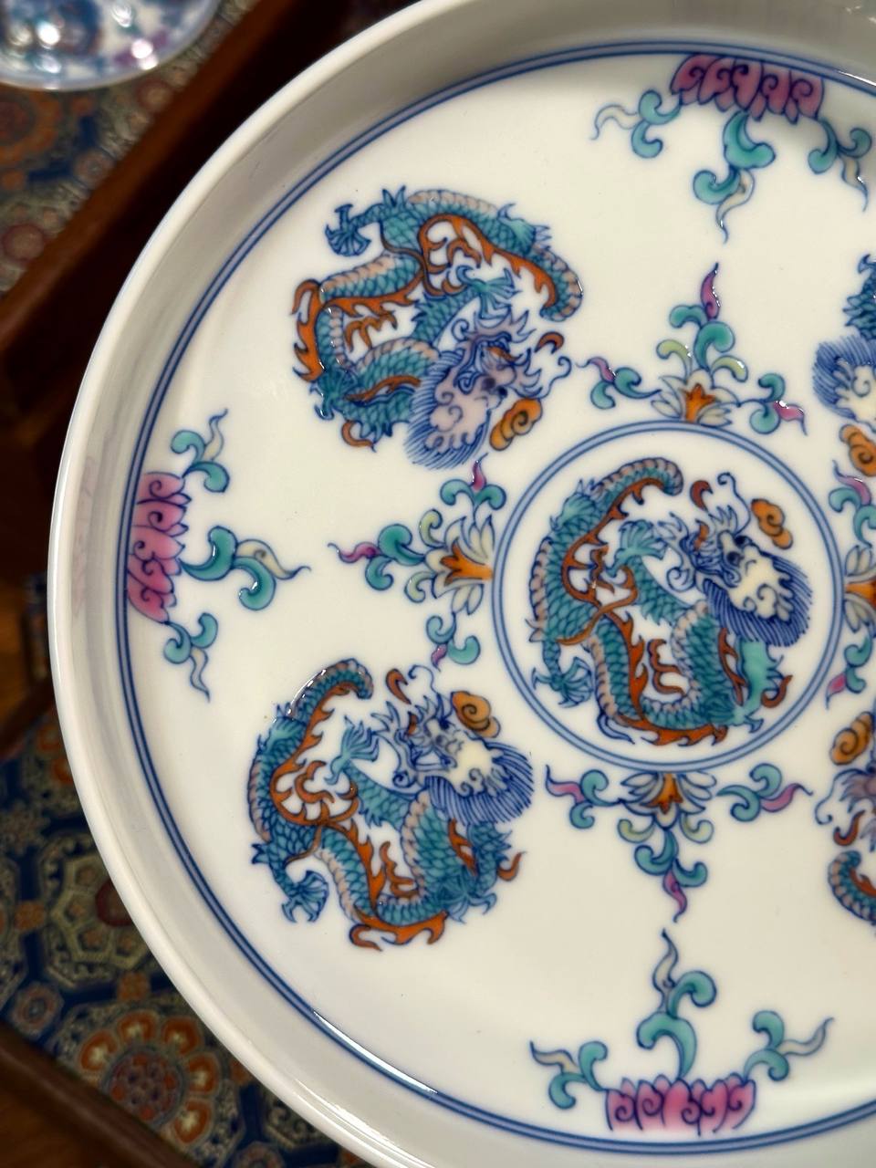 A three-piece hand-painted blue-and-white and doucai dragon-motif set. In traditional Chinese ceramic culture